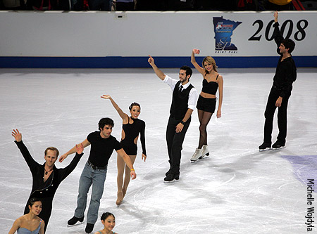 People dressed in black waving to the audience