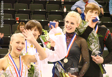 Smiling and waving with arms full of goodies