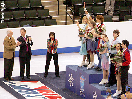 The medalists acknowledge the crowd