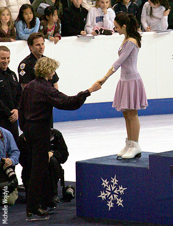 Meryl gives Charlie a hand onto the podium
