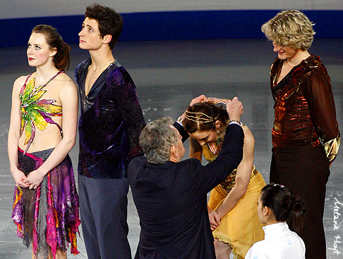 Meryl Davis receives the gold medal from David Dore