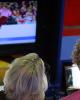 Adam Rippon and Karen Preston watch a replay of Adam's popped triple Axel