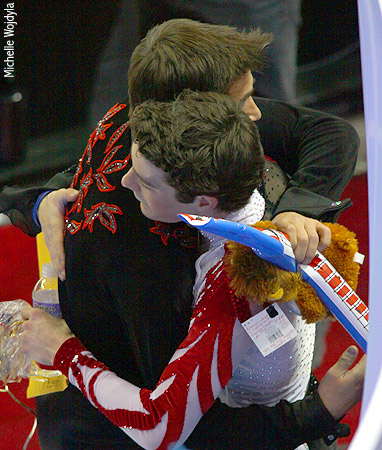 Brandon Mroz stayed to watch trainingmate Ryan Bradley's free skate and congratulates him at the end