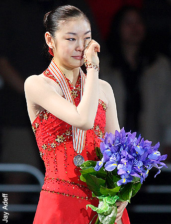 Yu-Na Kim (KOR) hears her national anthem being played