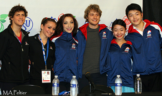 The top three teams after the free dance pose for a photo