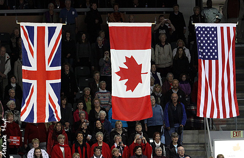 The flags of the medalists are raised