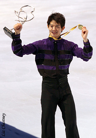 Takahiko Kozuka (JPN) shows off his medal and trophy to the crowd