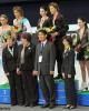 The event officials pose with the medalists