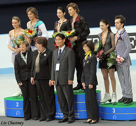 The event officials pose with the medalists