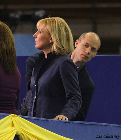 Kurt Browning peeks out behind Tracy Wilson during a break in the competition