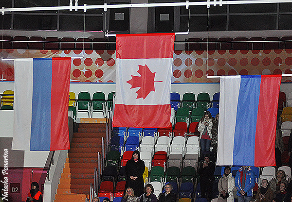 The medalists' flags are raised during the Canadian anthem