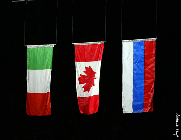The flags of the medalists are raised