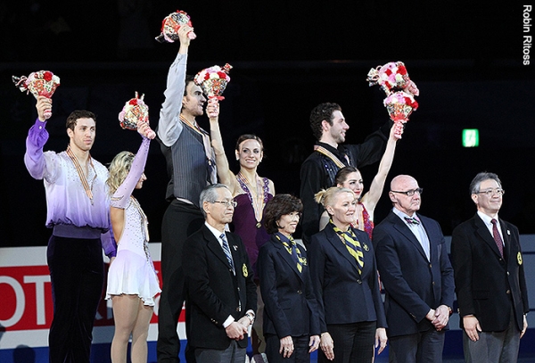The pairs medalists wave from atop the podium.
