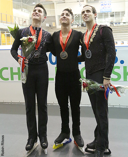 The men's medalists pose for fan photos