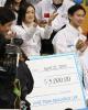 Shoma Uno (JPN) of Team Asia receives his check