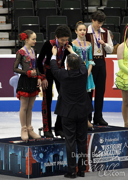 Caleb Wein receives his medal from U.S. Figure Skating President Samuel Auxier